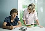 Teenage boy and girl doing homework together