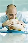 Man biting into large sandwich
