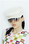 Teen girl wearing cap and sunglasses, portrait