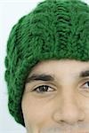 Young man wearing knit hat, portrait, close-up, partial view of face