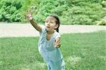 Girl reaching for bubbles