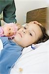 Girl lying in hospital bed