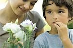 Boy and young woman with flowers, boy looking up