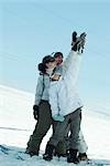 Group of snowboarders posing in snow, full length