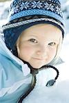 Toddler girl smiling at camera, dressed in winter clothing, portrait