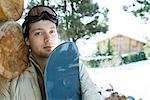 Young man with snowboard, portrait