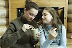 Teen girls having snack by fire place