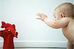 Baby reaching for puppet