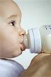 Baby drinking from bottle, extreme close-up, side view