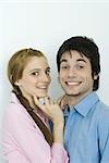 Young couple smiling at camera together, portrait