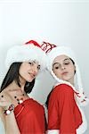 Two young female friends dressed in Christmas costumes, portrait