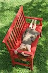 Little girl napping on bench