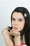 Teenage girl blowing a kiss at camera, portrait