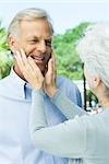 Mature woman touching her husband's face, close-up