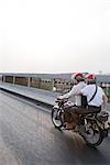 Two commuters riding motorbike together
