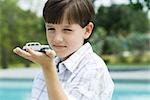 Boy holding toy car in palm of hand