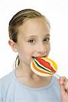 Little girl eating large lollipop, portrait