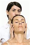 Woman receiving head massage, eyes closed