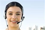 Young woman wearing headset, smiling at camera