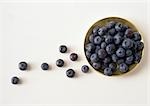 Bowl of blueberries against white background, high angle view