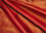 Folds in red fabric, close-up, full frame