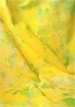 Yellow fabric with green splotches, close-up, full frame