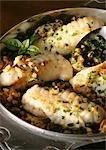 Filets of monkfish in dish with herbs, close-up