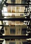 Printed newspaper on printing press, blurred motion