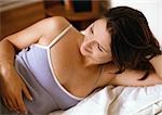 Woman laying in bed, smiling