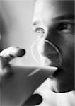 Man drinking from glass, close-up, blurred, b&w