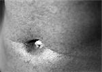 Man's belly button, close up, black and white.