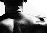 Mannes Nacken- und Schultermassage, close up, Ansicht von hinten, schwarz und weiß.