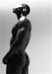 Nude man standing, defocused, black and white.