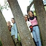 Young people standing between trees