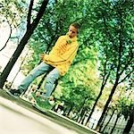 Teenage boy with skateboard outside