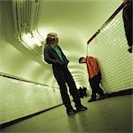 Young people standing in subway corridor