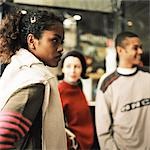 Young people standing in front of shop