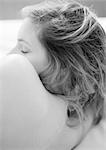 Woman lying on side, close-up of bare back, shoulder and head, black and white