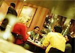 Group of young people sitting in restaurant