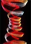 Spiraling light effects, one within the other, reds and yellows.