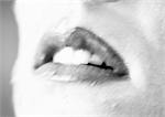 Woman's open mouth, close up, black and white, blurred.