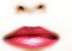 Woman's mouth with red lipstick, blurred extreme close-up
