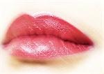 Woman's mouth with lipstick, blurred, extreme close-up