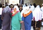 Israel, Jerusalem, women wearing headscarves walking in crowded street, rear view