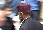 Israel, Jerusalem, Muslim man, rear view, blurred motion of people passing in background