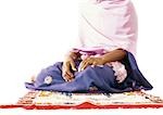 Muslim woman sitting on prayer rug