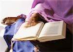 Muslim woman with manuscript, blurry.
