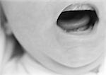 Baby's open mouth, close-up, b&w