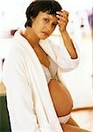 Pregnant woman in open bathrobe, portrait