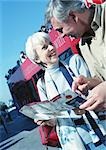 Mature woman and man examining a brochure